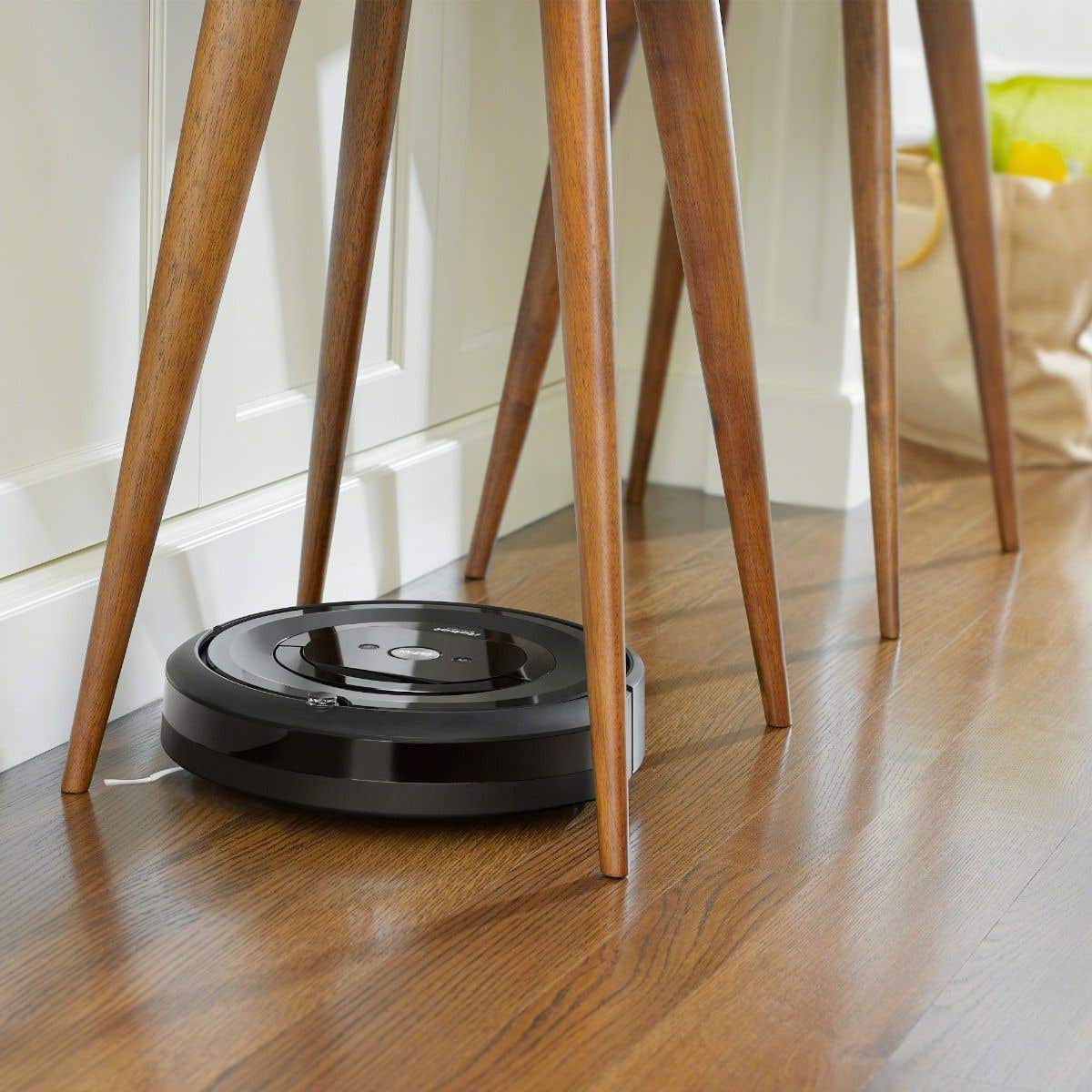 iRobot-Roomba-i7-Wi-Fi-Connected-Robot-Vacuum-Cleaner-listing-under-chair.